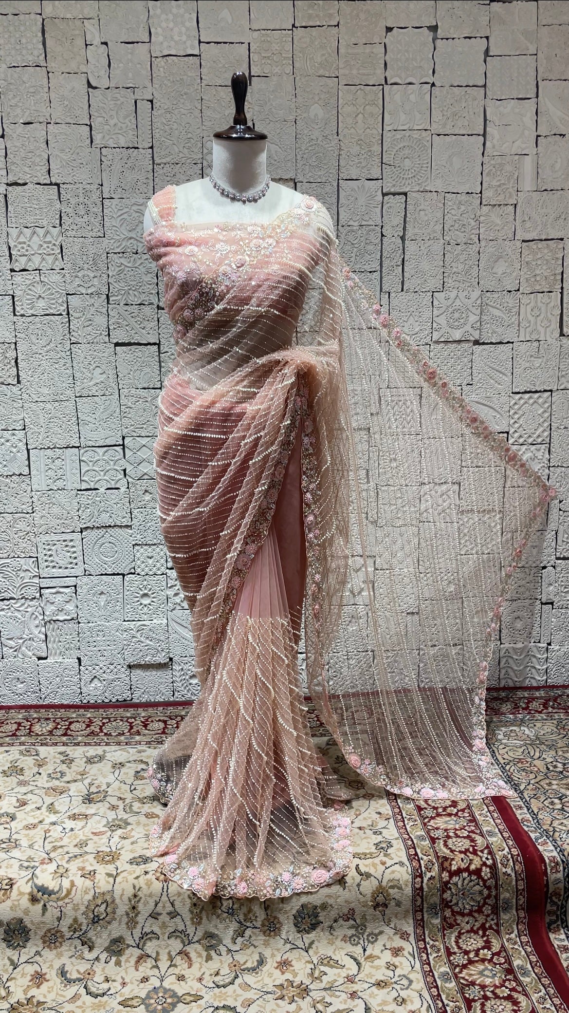 Pastel pink net saree with floral motifs