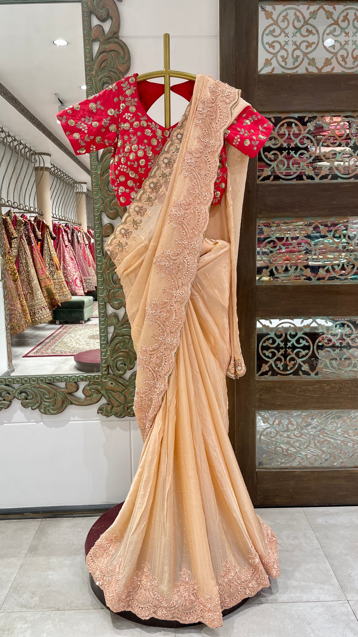 Peach Saree with Embellished Border and Red Embroidered Blouse